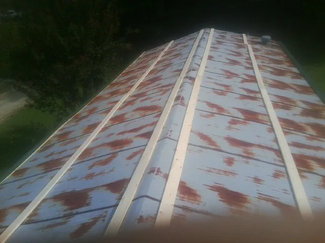 Rusted metal roof panels with new wood purlins before replacement — Storm Damage Roof Repair in Uncasville by Roofing Brothers